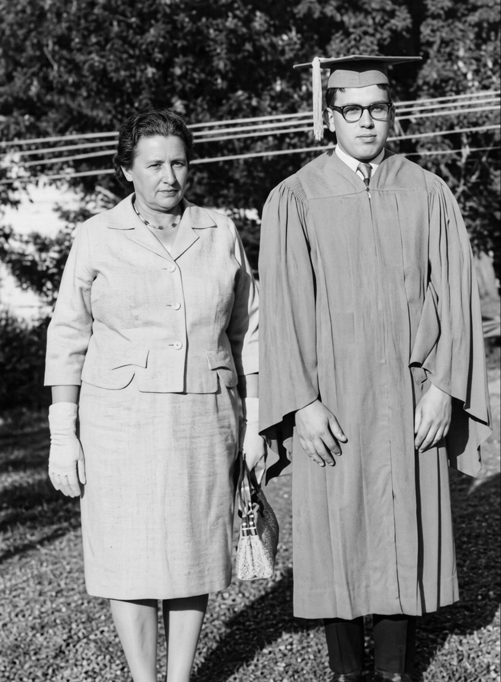 Norma beside her son in his graduation cap and gown